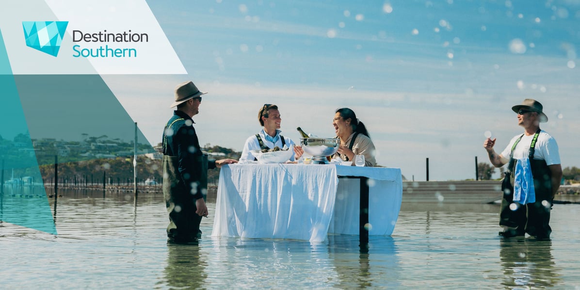 Couple on an oyster tasting experience on the waters of Merimbula Lake with Merimbula Oyster Tours. Credit: Destination NSW
